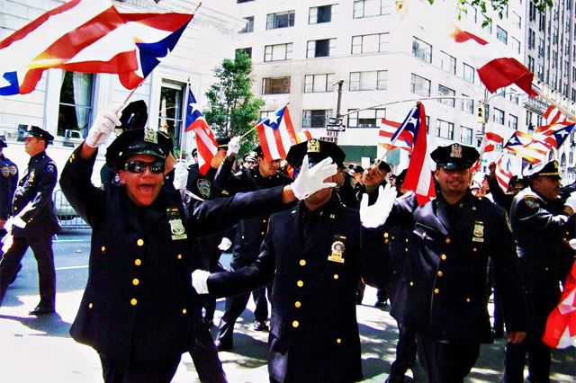 Puerto Rican members of the NYPD greeting revelers.